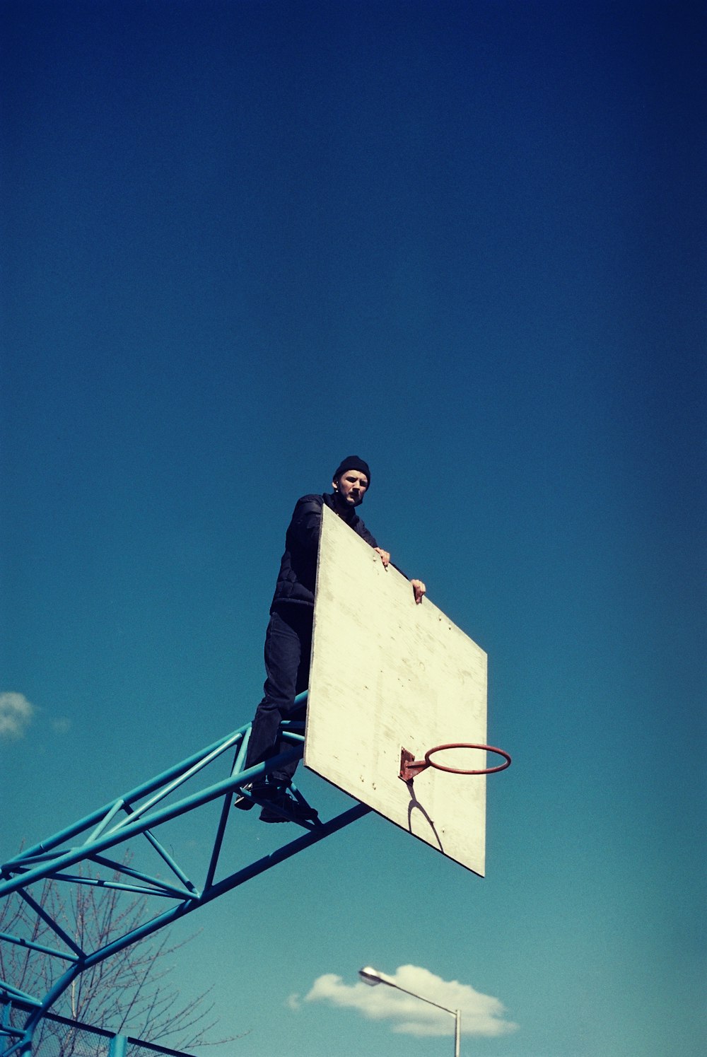 a man sitting on top of a basketball court