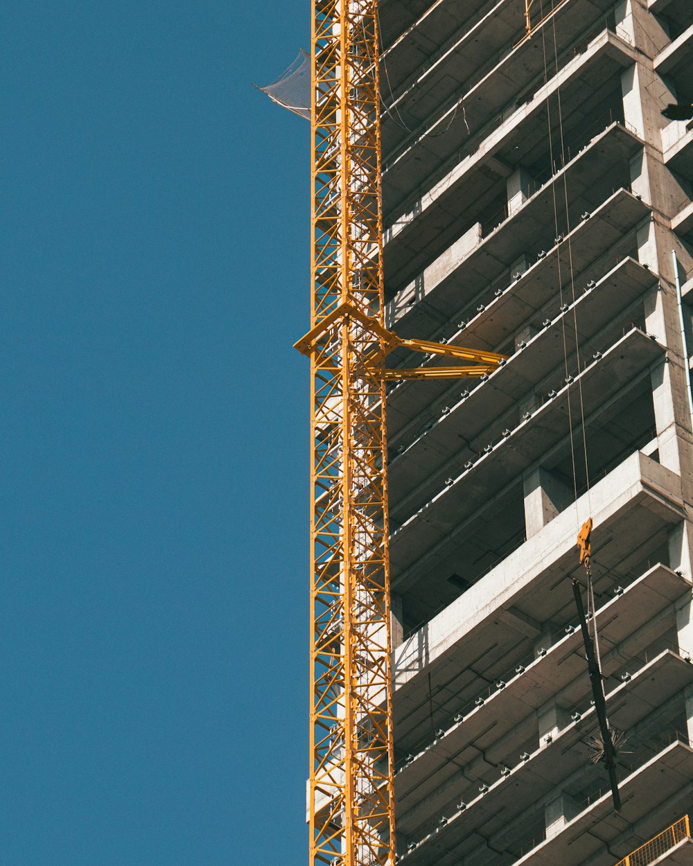 a crane is attached to the side of a tall building