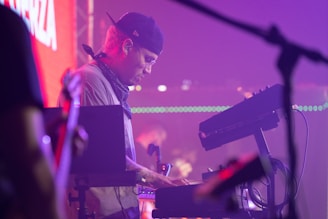 a man playing a keyboard in front of a microphone