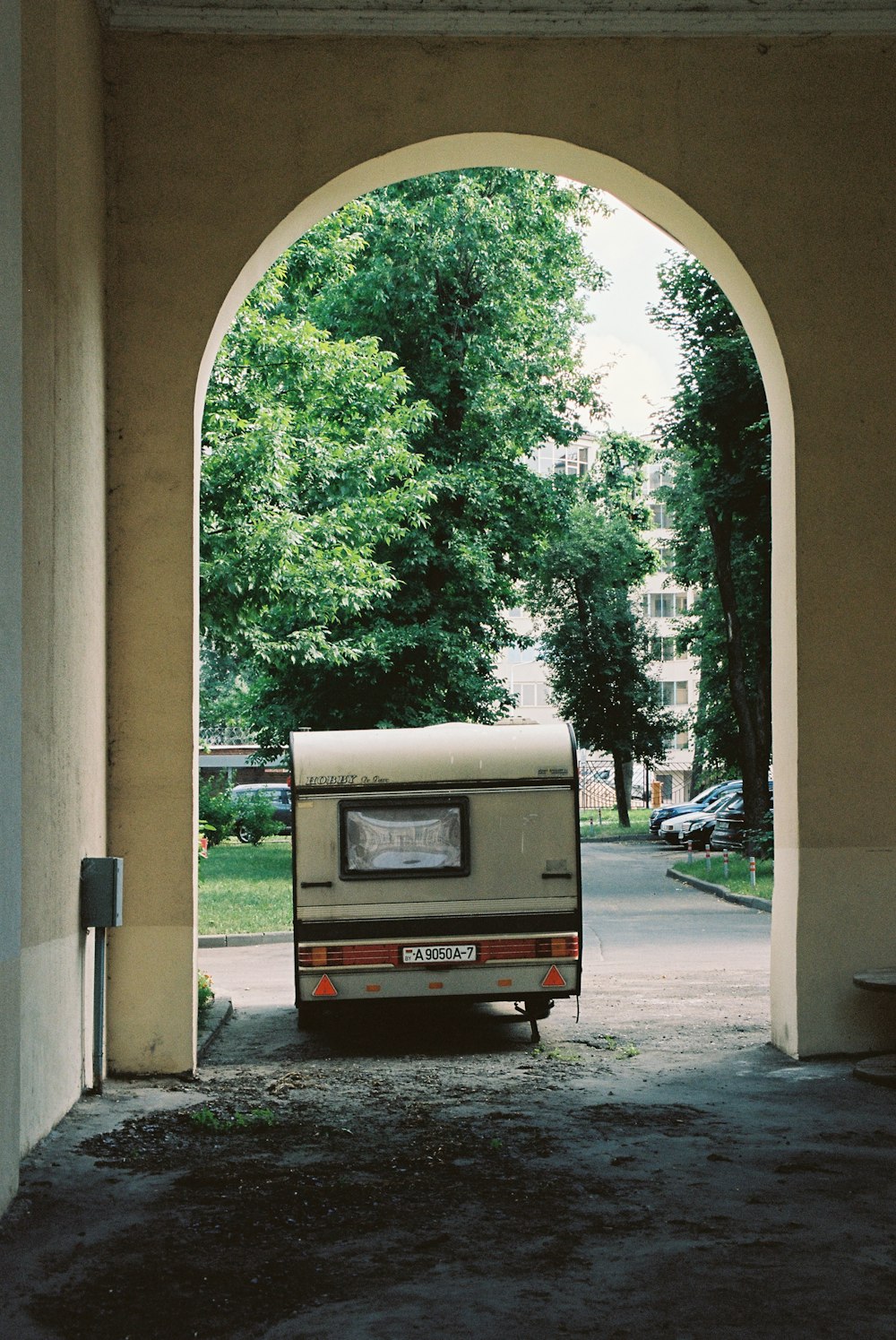 an rv parked under an archway in a park