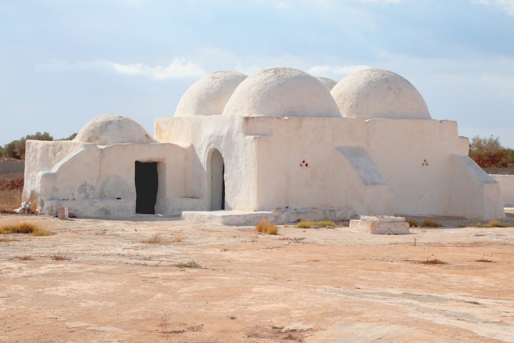 a large white building sitting in the middle of a desert