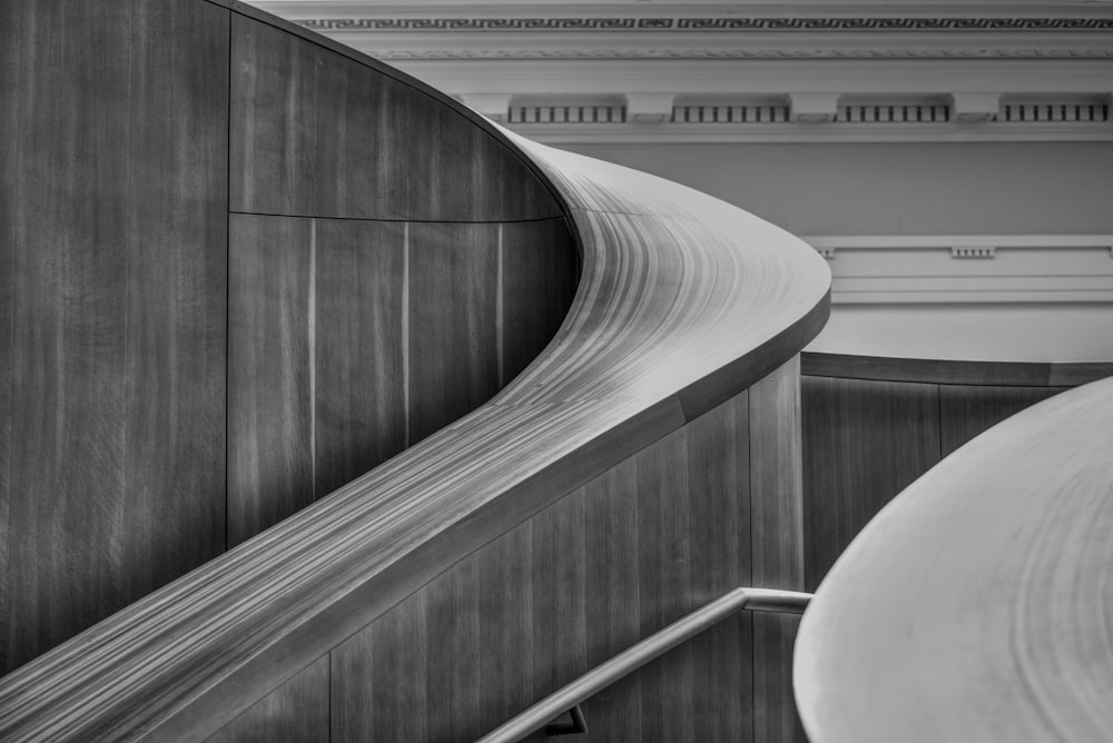 a black and white photo of a curved staircase