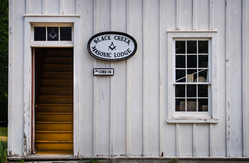 a white building with a black and white sign on it