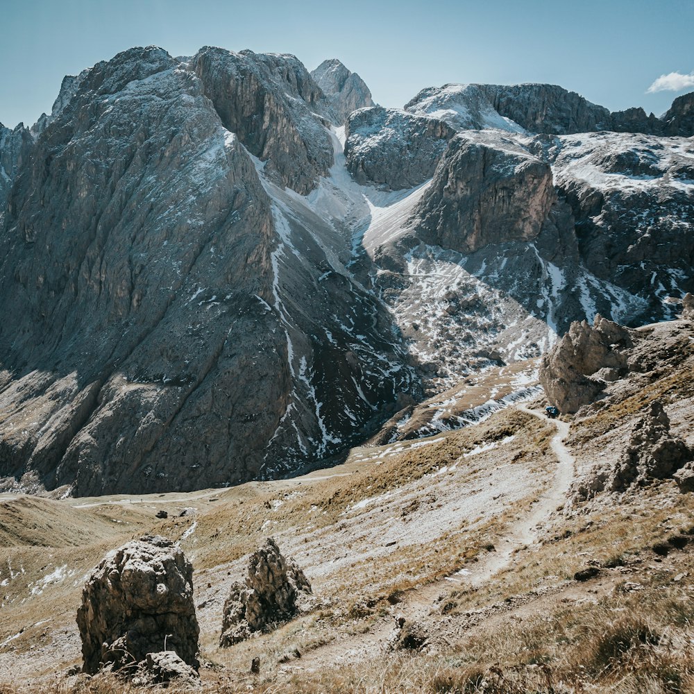 a rocky mountain range with snow on the top