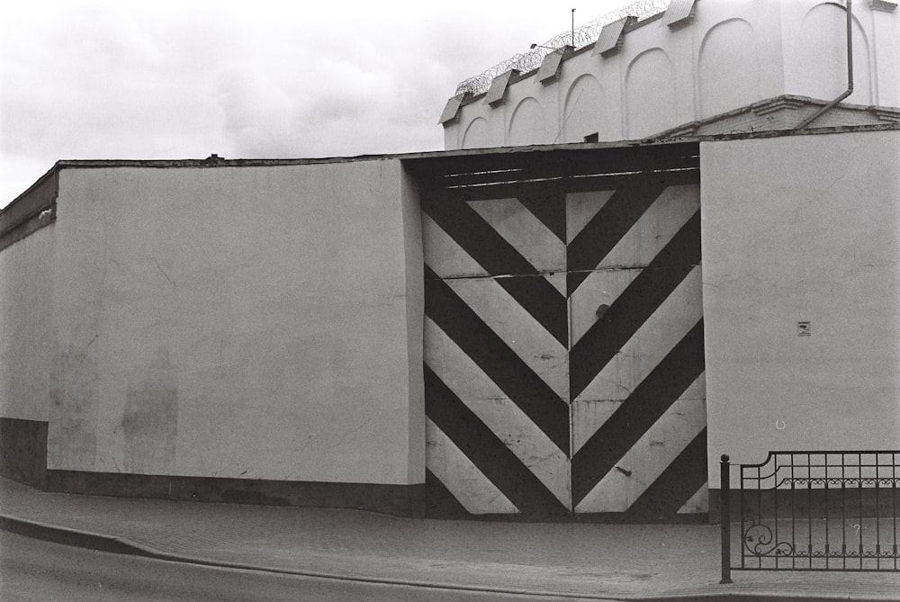 a black and white photo of a building with a large door