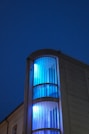a tall building with a blue light on it's side