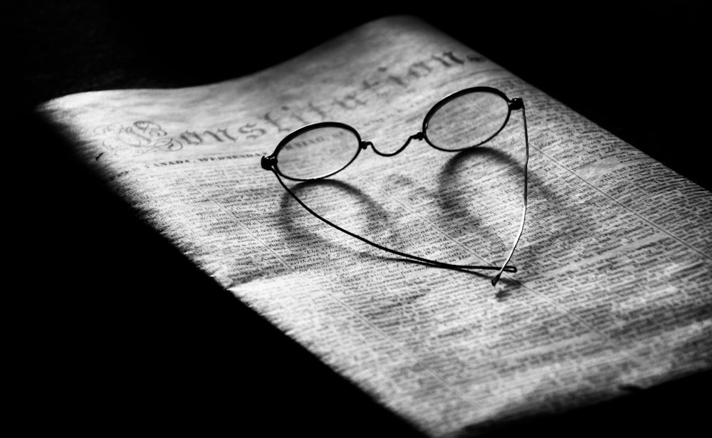 a pair of glasses sitting on top of a napkin