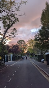 A sunset stroll along a quiet street with two people sharing a lighthearted moment.