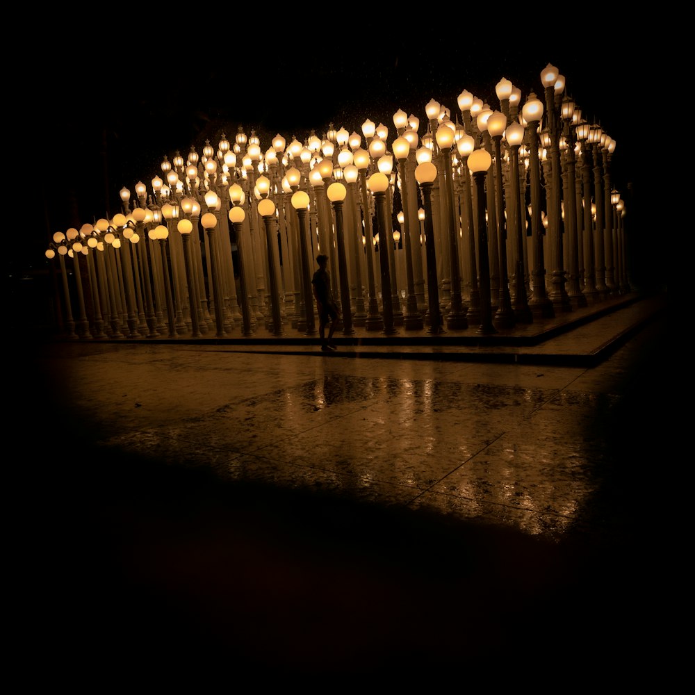 a person standing in front of a bunch of lights