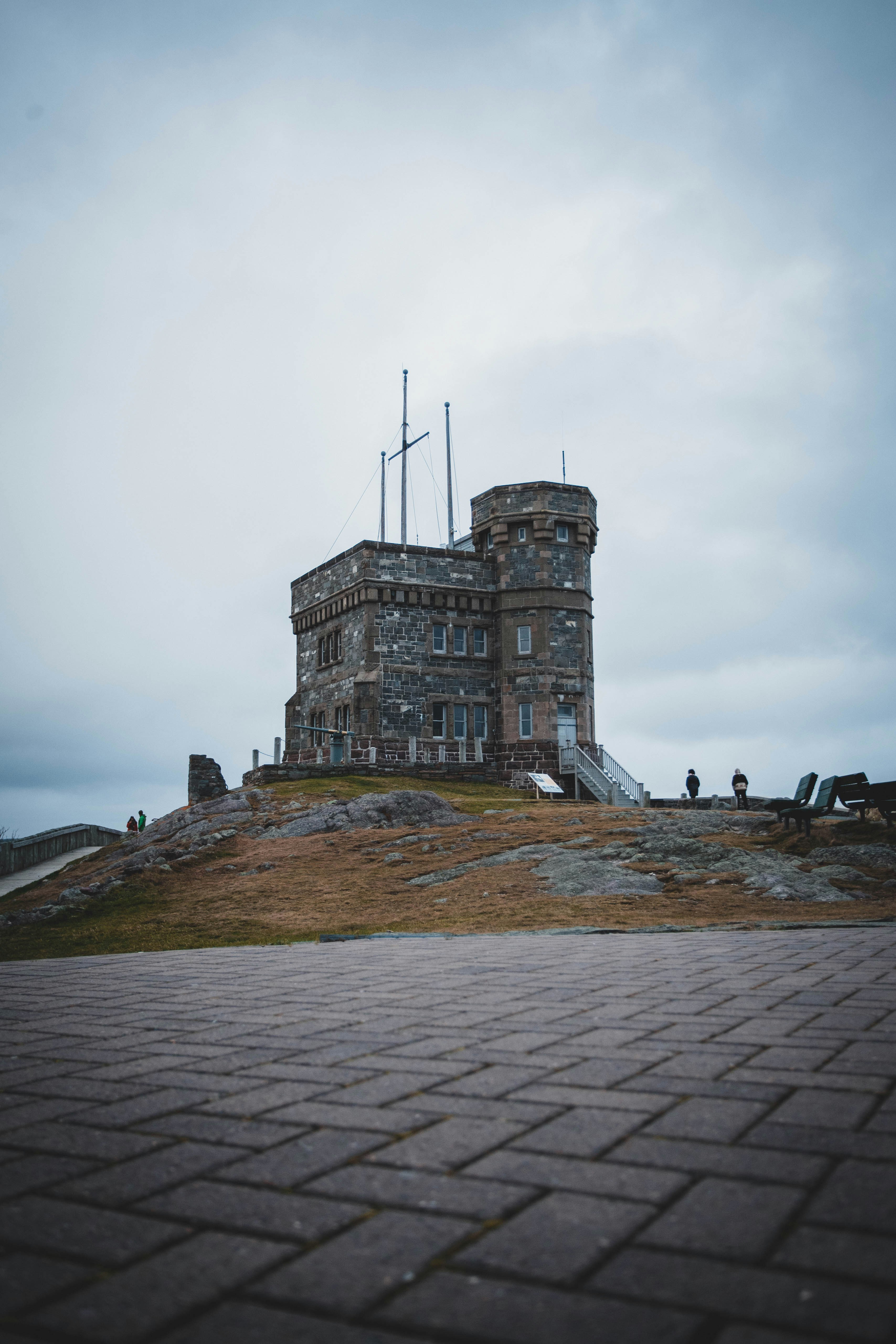 a stone building with a flag on top of it