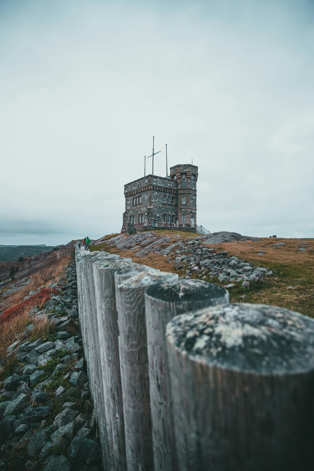 a tall building sitting on top of a rocky hill