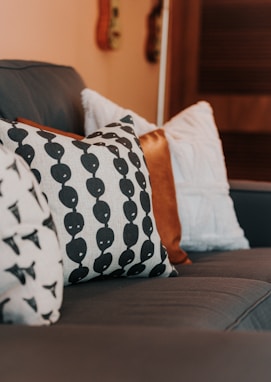 a close up of a couch with pillows on it