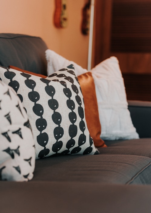 a close up of a couch with pillows on it