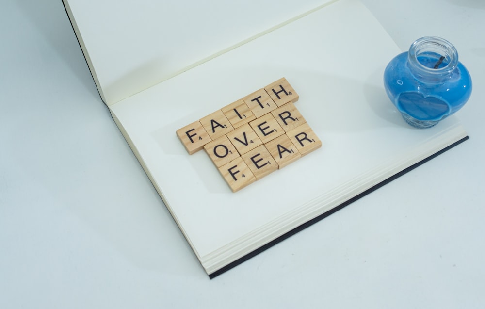 a scrabble of letters spelling faith over fear