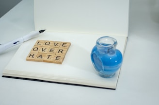 a scrabble of love over hate on a notebook