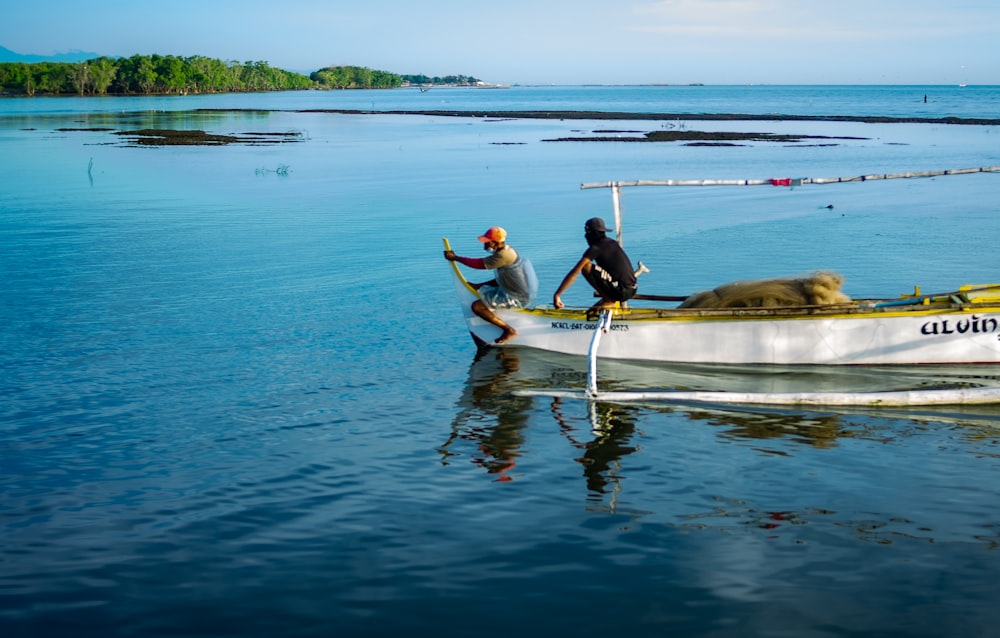 two people in a small boat on a body of water