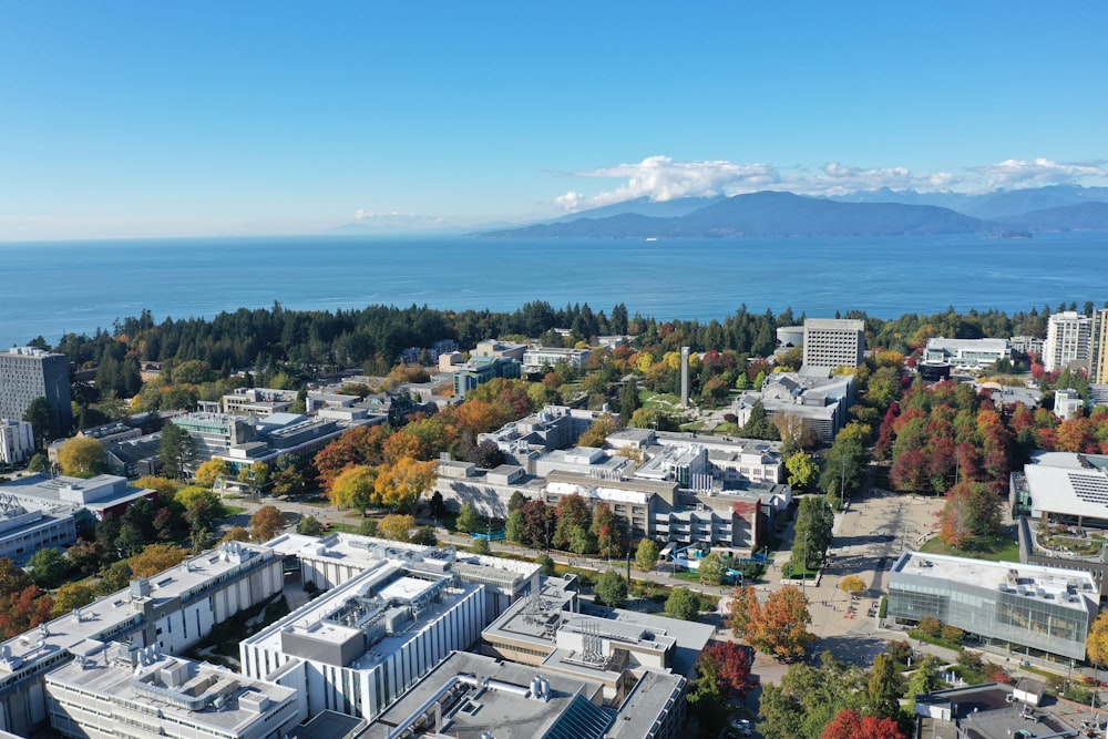 an aerial view of a city with mountains in the background