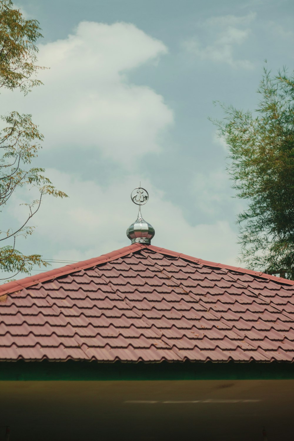 a red roof with a weather vane on top