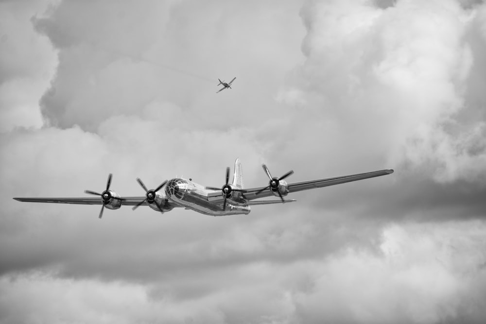 a plane is flying in the cloudy sky