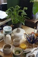 a wooden table topped with lots of craft supplies By Nam Quach on Unsplash