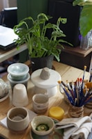 a wooden table topped with lots of craft supplies By Nam Quach on Unsplash