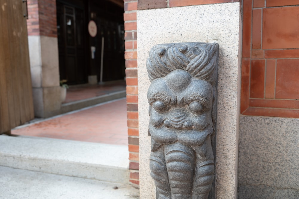 a stone statue of a woman holding a baby