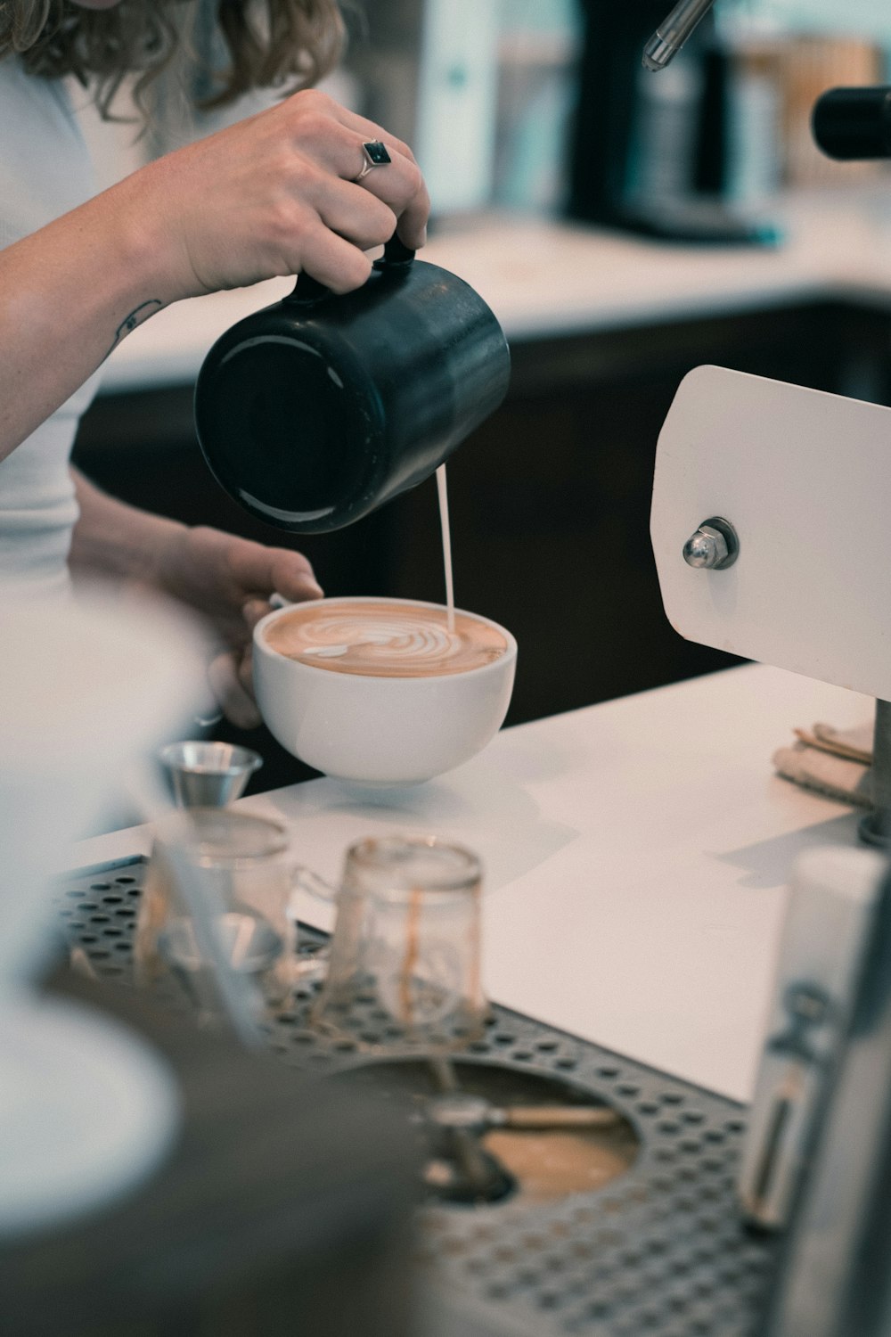 a woman is pouring a cup of coffee