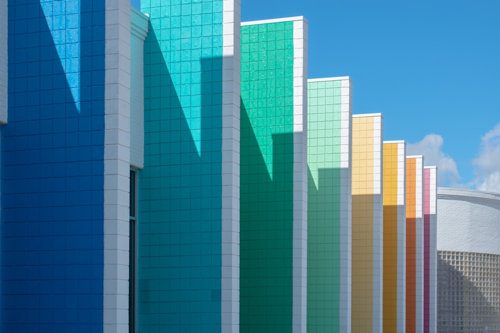 a row of multicolored buildings against a blue sky