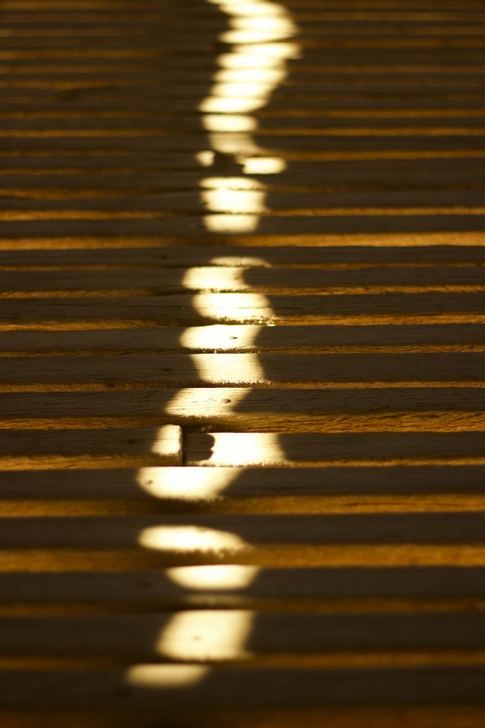 a shadow of a person walking across a street