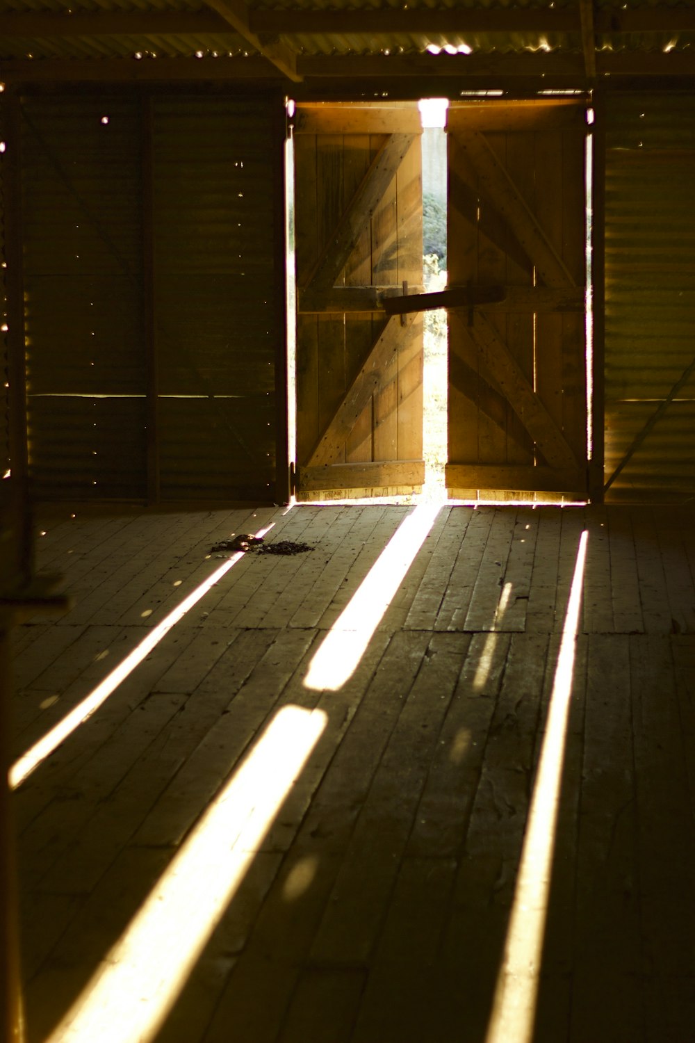 the sun is shining through the open doors of a building