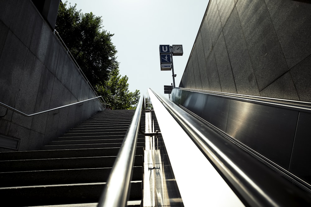 a set of stairs leading up to a street sign