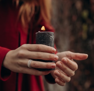 a woman holding a candle in her hands