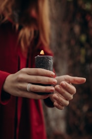 a woman holding a candle in her hands