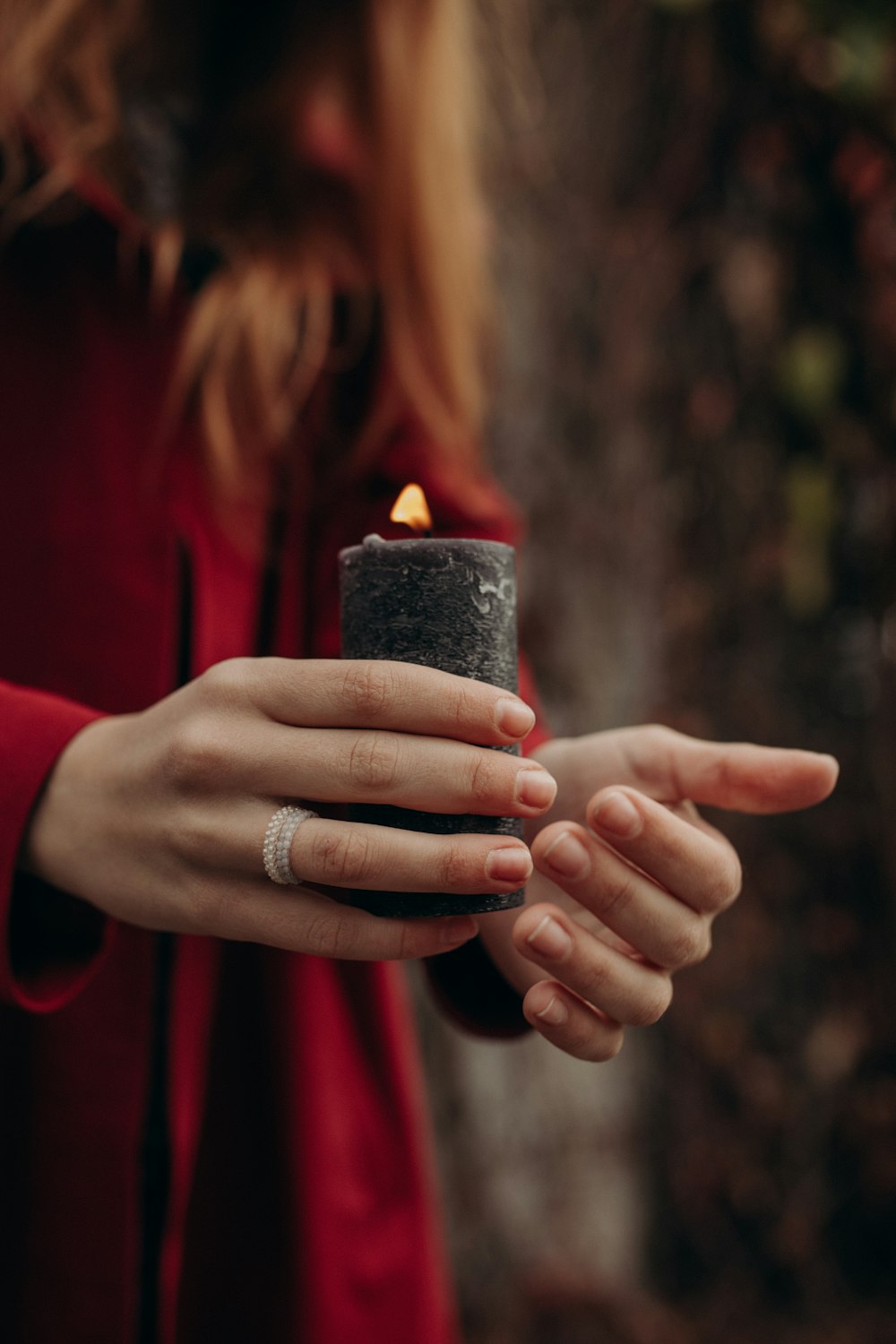 a woman holding a candle in her hands