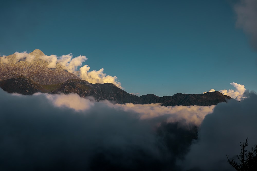 a view of a mountain covered in clouds