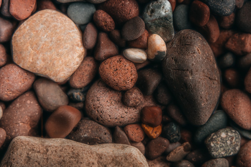 a close up of rocks and pebbles on a beach