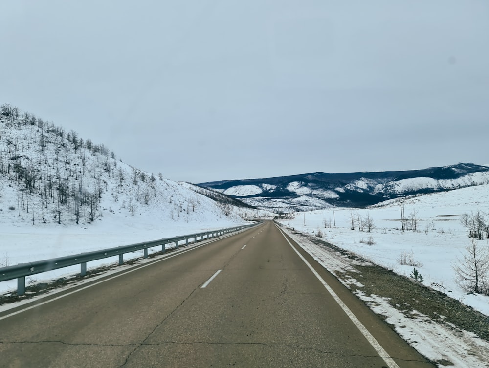 a road in the middle of a snowy landscape