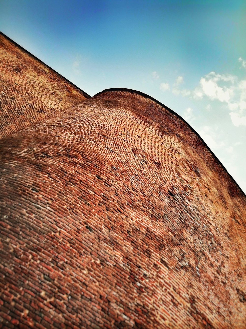 a red brick building with a blue sky in the background