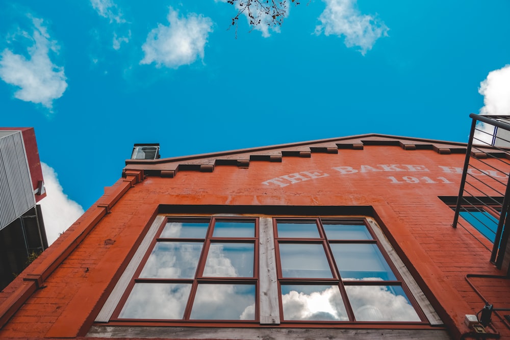 a red brick building with windows and a sky background