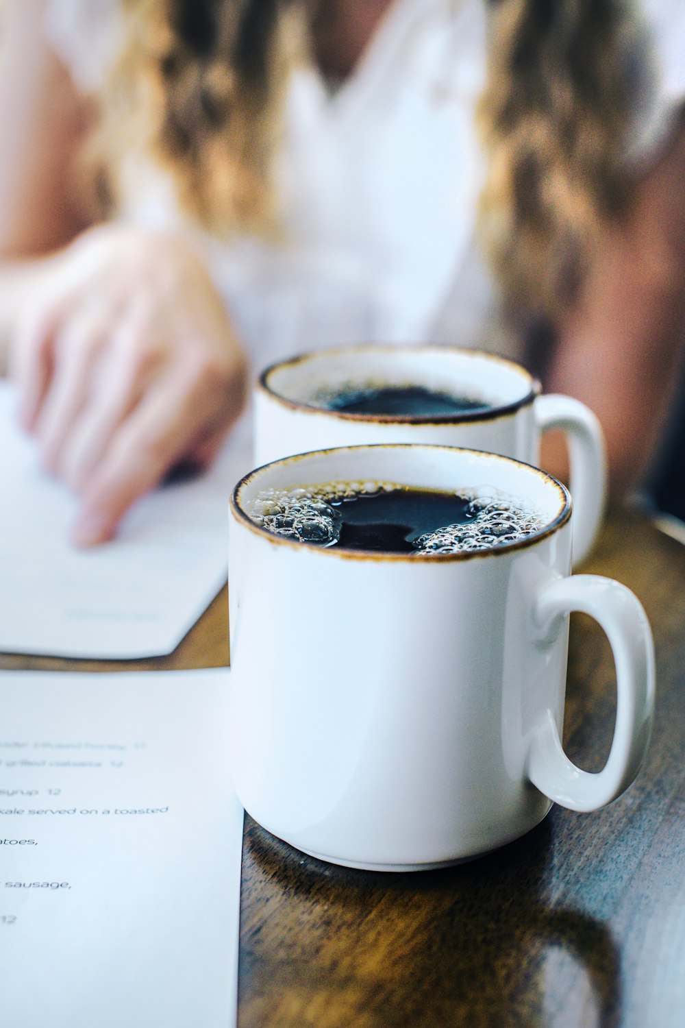 two cups of coffee sit on a table