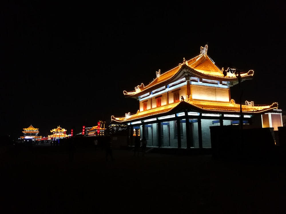 a building lit up at night with lights on it