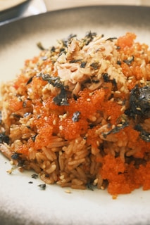 a white plate topped with rice and vegetables