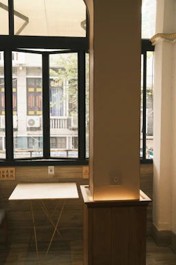 A cozy corner with custom teak wood furniture bathed in warm natural light.