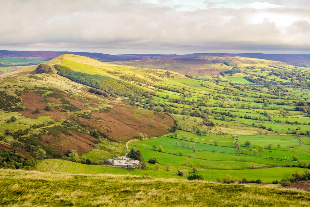 a view of a valley with a house in the middle of it