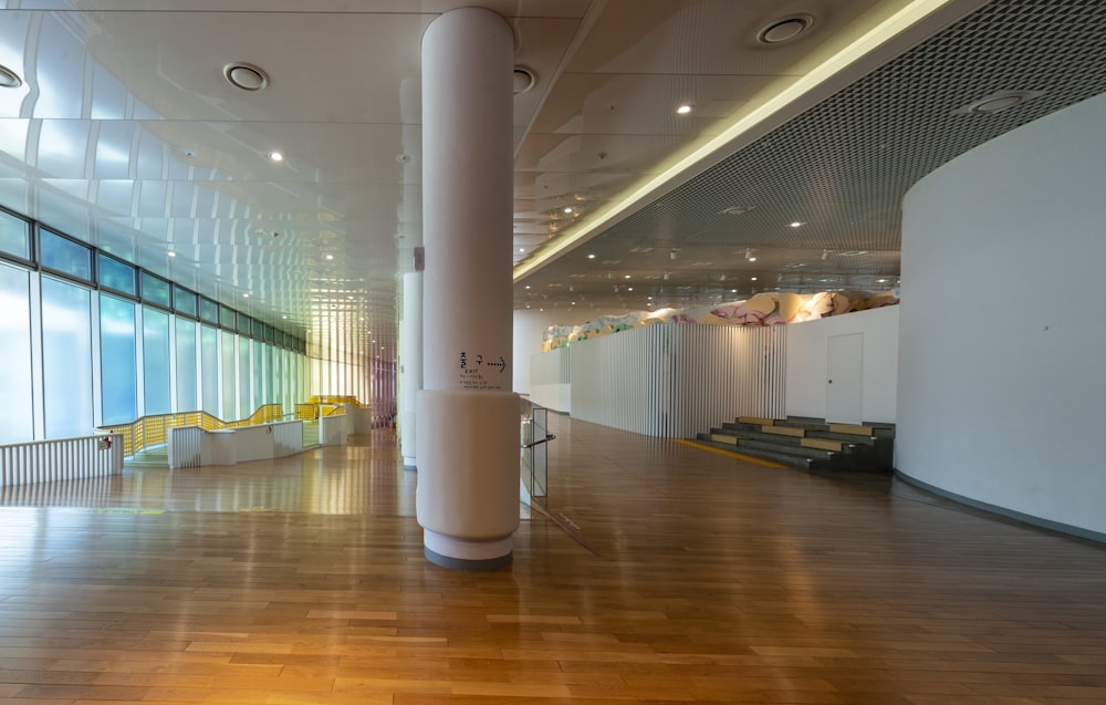 a large room with a wooden floor and white walls