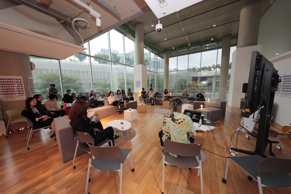 a group of people sitting in chairs in a room