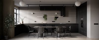 Modern kitchen area with sleek dark tones and subtle golden lighting, highlighting clean surfaces.