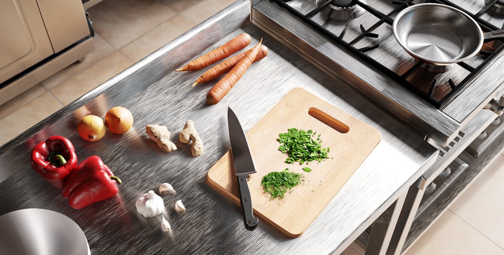 a kitchen counter with a cutting board, knife and vegetables
