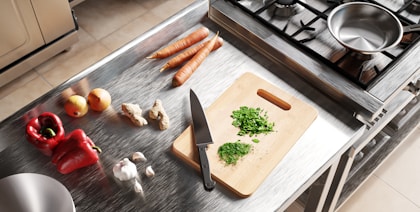 Kitchen counter with fresh vegetables and cutting board