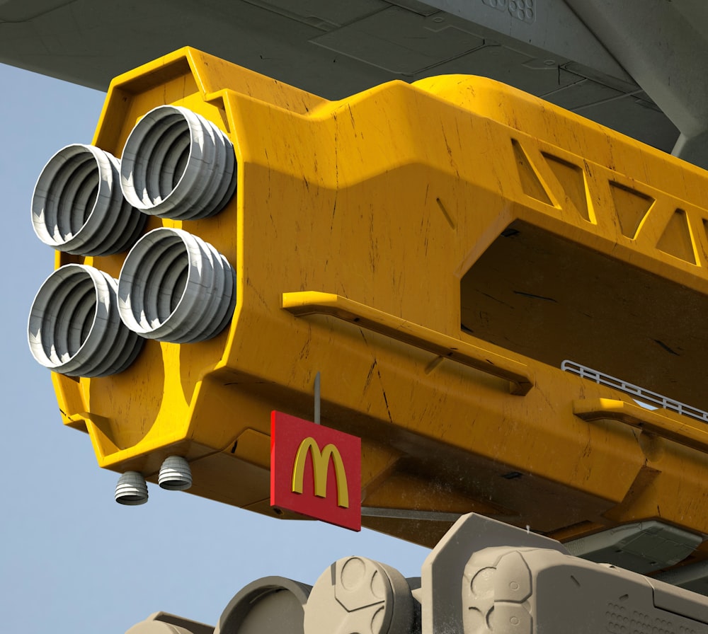 a close up of a yellow crane with a mcdonald's sign